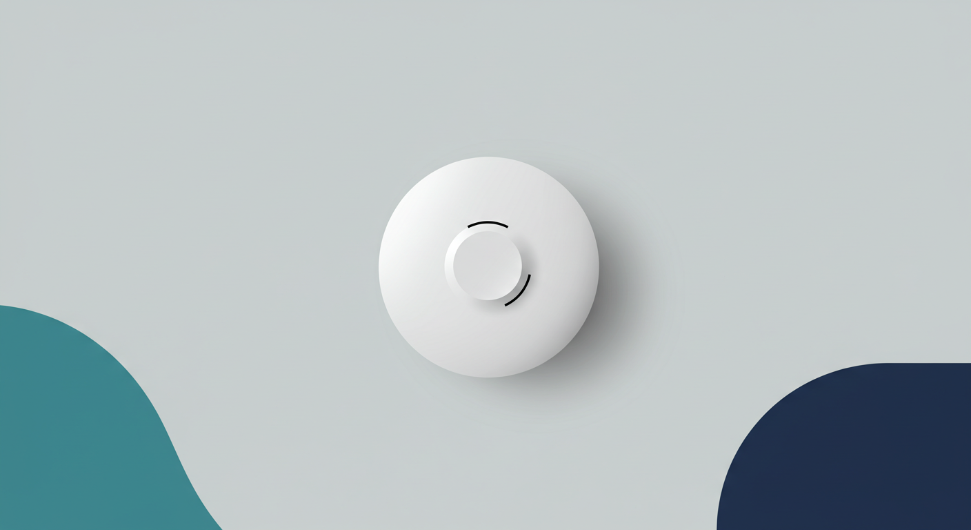 A modern, white carbon monoxide detector mounted on a light gray wall in a home hallway.